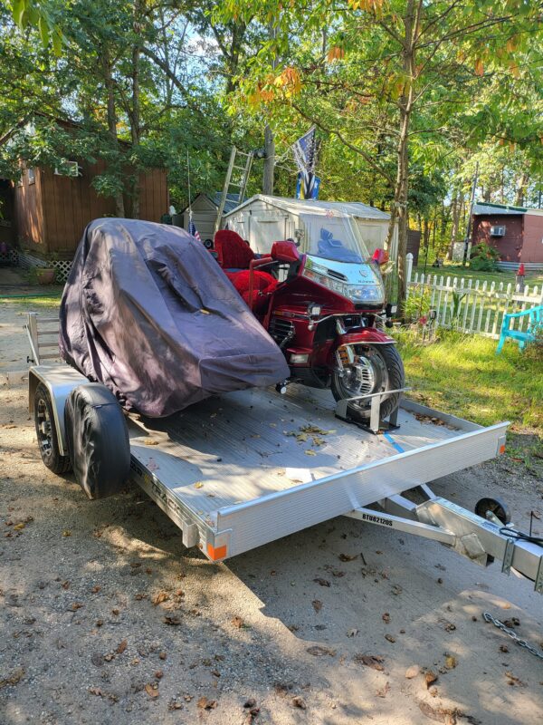 An all aluminum trailer loaded with two bikes.