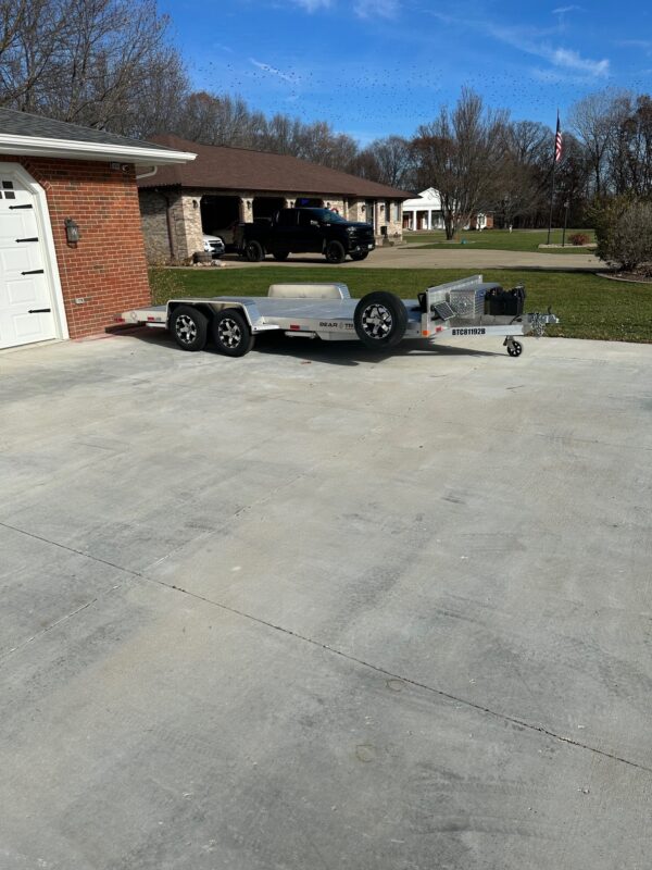 An all aluminum Bear Track car hauler parked in a driveway.